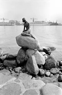 The statue of the Little Mermaid guards the entrance to the port of Copenhagen May The statue of the Little Mermaid guards the entrance to the port of Copenhagen May