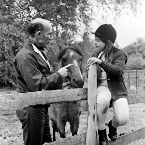 Images Dated 26th June 1974: Sterling Moss (Ex Racing Driver). Seen here with horse and daughter. June 1974 S74-3861