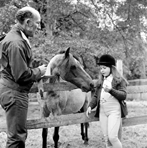 Images Dated 26th June 1974: Sterling Moss (Ex Racing Driver). Seen here with horse and daughter