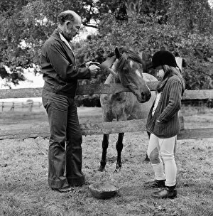 Images Dated 26th June 1974: Stirling Moss and his daughter Allison (aged 7) with her horse Happy