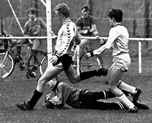 Stockton West End keeper Mark Woolnough dives at the feet of Michael Bates to rescue his Stockton West End keeper Mark Woolnough dives at the feet of Michael Bates to rescue his