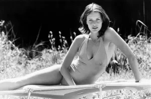Sylvia Kristel in a swimsuit on a folding bed, on her side Sylvia Kristel in a swimsuit on a folding bed, on her side