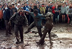T in the Park July 1997 People mud fighting at T in the Park at Balado Airfoeld near T in the Park July 1997 People mud fighting at T in the Park at Balado Airfoeld near