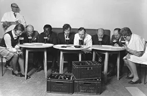A tasting panel of men and women smell the aroma from glasses of Guiness at the Park A tasting panel of men and women smell the aroma from glasses of Guiness at the Park