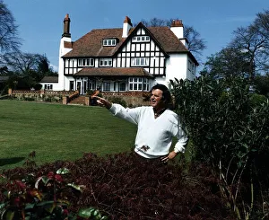 Terry Wogan Radio and TV Presenter stands and points in his garden in front of his house Terry Wogan Radio and TV Presenter stands and points in his garden in front of his house