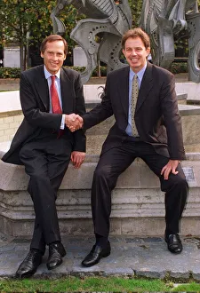 Tony Blair shakes hands with new MP Tony Howarth sitting at a fountain with sculpture in Tony Blair shakes hands with new MP Tony Howarth sitting at a fountain with sculpture in