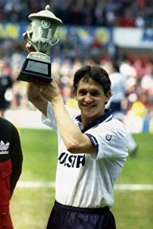 Images Dated 2nd May 1992: Tottenham Hotspurs striker Gary Lineker holds aloft a trophy presented by Bryan Robson