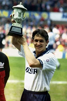 Tottenham Hotspurs striker Gary Lineker holds aloft a trophy presented by Bryan Robson Tottenham Hotspurs striker Gary Lineker holds aloft a trophy presented by Bryan Robson