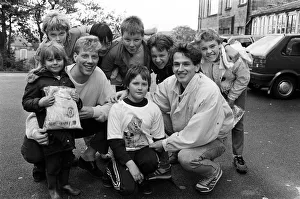 Town footballers Simon Webster (left) and Julian Winter size up young Jason Rushworth for Town footballers Simon Webster (left) and Julian Winter size up young Jason Rushworth for