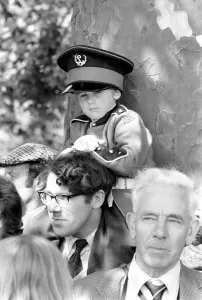Trooping the colour ceremony in London. Little boy watching the ceremony wearing a large Trooping the colour ceremony in London. Little boy watching the ceremony wearing a large