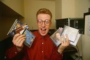 Images Dated 1st July 1995: TV presenter Bryan Burnett holding various CD s