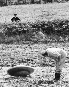 UFO being inspected by farmer Jennings after landing in his field whilst a police officer UFO being inspected by farmer Jennings after landing in his field whilst a police officer