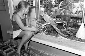 Unusual: Animals: 'Trapped Parrot'. Little Ann Grange aged 10 sits Unusual: Animals: 'Trapped Parrot'. Little Ann Grange aged 10 sits