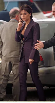 Victoria Adams Posh Spice talks on her mobile telephone as she prepares to leave with Victoria Adams Posh Spice talks on her mobile telephone as she prepares to leave with