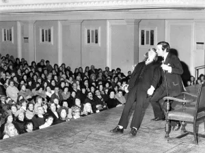 A volunteer collapses into the arms of Romark, a hypnotist A volunteer collapses into the arms of Romark, a hypnotist