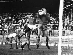) watches as City defender Gary Bennett challenges for the ball with Hereford United ) watches as City defender Gary Bennett challenges for the ball with Hereford United