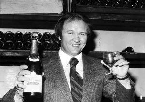 West Bromwich Albion football manager Ron Atkinson holds up a bottle of champagne at West Bromwich Albion football manager Ron Atkinson holds up a bottle of champagne at
