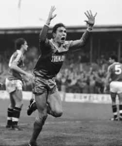 Wimbledon footballer Vinnie Jones raises his arms as he celebrates scoring the game' Wimbledon footballer Vinnie Jones raises his arms as he celebrates scoring the game'