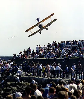 A wing walker performs on the Cadbury's Crunchie Boeing-Stearman Model 75 biplane at A wing walker performs on the Cadbury's Crunchie Boeing-Stearman Model 75 biplane at