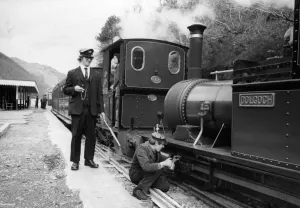 A woker applying some oil to one of the steam trains on the Talyllyn railway line which A woker applying some oil to one of the steam trains on the Talyllyn railway line which