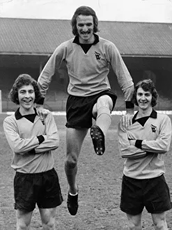 Wolves striker Derek Dougan swings between team mates Alan Sunderland (left Wolves striker Derek Dougan swings between team mates Alan Sunderland (left