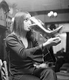 Woman drinking from a glass boot holding nearly 5 pints of lager Woman drinking from a glass boot holding nearly 5 pints of lager