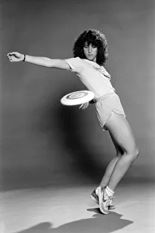 A woman performing exercises with a frisbee. June 1980 A woman performing exercises with a frisbee. June 1980