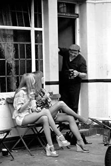 Two women stop at a pub to have a pint of beer while shopping on Kings Road in Chelsea Two women stop at a pub to have a pint of beer while shopping on Kings Road in Chelsea