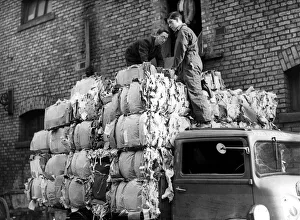 Workers load a lorry with 50 bales of salvaged paper weighing three tons at Newcastle Workers load a lorry with 50 bales of salvaged paper weighing three tons at Newcastle