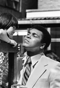 World Heavy-weight boxing champion Muhammad Ali with a little girl from Great Ormond World Heavy-weight boxing champion Muhammad Ali with a little girl from Great Ormond
