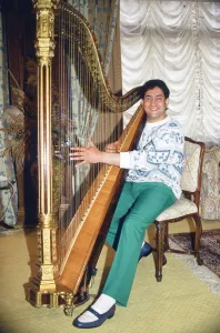World snooker champion Joe Johnson poses playing a harp. 28th May 1986 World snooker champion Joe Johnson poses playing a harp. 28th May 1986
