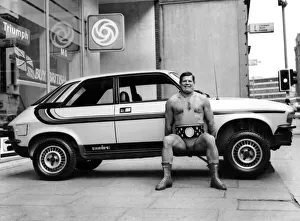 Wrestler Geoff Condliffe known as Count Bartelli lifting a car Wrestler Geoff Condliffe known as Count Bartelli lifting a car