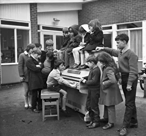 Eleven year old Martin Hawes entertains his school friends to a tune on the John Lennon Eleven year old Martin Hawes entertains his school friends to a tune on the John Lennon