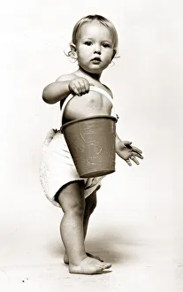 Four year old Oliver Cowley aged 18 months poses with a bucket as part of a horoscope Four year old Oliver Cowley aged 18 months poses with a bucket as part of a horoscope