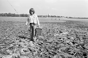Young boy goes for a spot of fishing at dried out Edgbaston reservoir in Birmingham Young boy goes for a spot of fishing at dried out Edgbaston reservoir in Birmingham