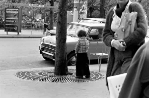 Young boy urinates outside a cafe on the Champs Elysees in Paris, France Young boy urinates outside a cafe on the Champs Elysees in Paris, France