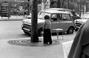 Young boy urinates outside a cafe on the Champs Elysees in Paris, France Young boy urinates outside a cafe on the Champs Elysees in Paris, France