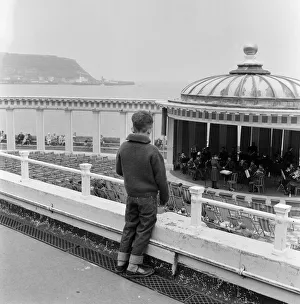 A young boy watching a band playing in the bandstand at Scarborough, North Yorkshire A young boy watching a band playing in the bandstand at Scarborough, North Yorkshire