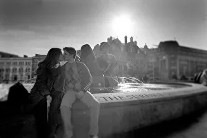 A young couple take advantage of the unusual warm weather in Victoria Square A young couple take advantage of the unusual warm weather in Victoria Square