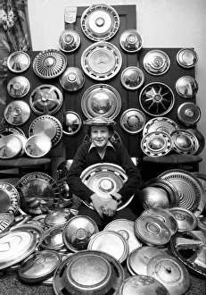 Young David and his collection of 130 caps. He collects hub caps that fly off care near Young David and his collection of 130 caps. He collects hub caps that fly off care near
