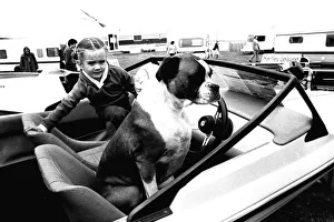 A young girl and her dog try out a speedboat at the Whitley Bay Motor Show. 18/07/80 A young girl and her dog try out a speedboat at the Whitley Bay Motor Show. 18/07/80