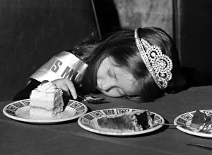 A young girl fall asleep on the table whilst eating a peice of cake - Childrens A young girl fall asleep on the table whilst eating a peice of cake - Childrens