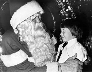 A young girl meeting Father Christmas in the grotto at Debenham's, Teesside A young girl meeting Father Christmas in the grotto at Debenham's, Teesside
