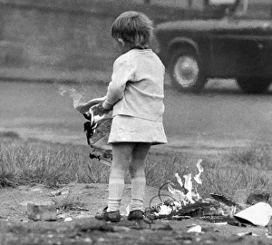 A young girl risks injury playing with fire on wasteland November 1972 A young girl risks injury playing with fire on wasteland November 1972