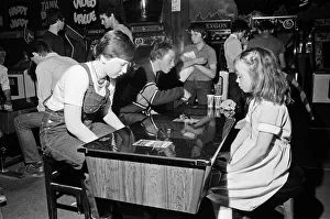 Young holidaymakers play the video machines at the James Corrigan seafront amusement Young holidaymakers play the video machines at the James Corrigan seafront amusement