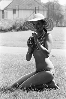 Young lady cools down with a refreshment as she enjoys the summer heatwave, Teesside Young lady cools down with a refreshment as she enjoys the summer heatwave, Teesside