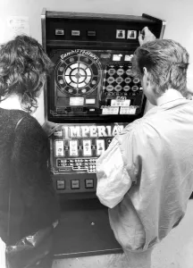 Young people playing on a one armed bandit or electronic gaming machine in September 1983 Young people playing on a one armed bandit or electronic gaming machine in September 1983