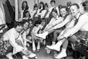Young roller skaters lace up their boots and chat back stage as they prepare to take part Young roller skaters lace up their boots and chat back stage as they prepare to take part