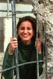 Young woman looks through a hole in the Berlin wall-pictured on the Jean Rook trip to Young woman looks through a hole in the Berlin wall-pictured on the Jean Rook trip to