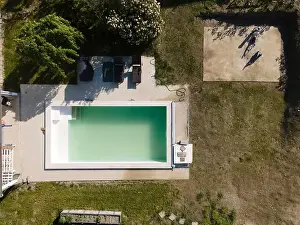 Drone Flight Print over Unmaintained Pool in Lush Greenery